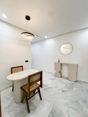 a white room with a table and chairs at Luxe Studio Gueliz in Marrakech