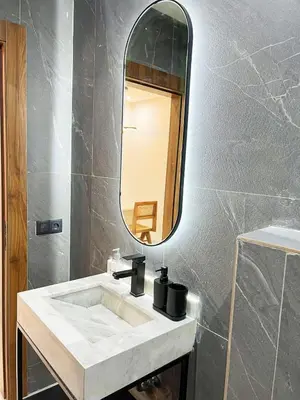 a bathroom with a white sink and a mirror at Luxe Studio Gueliz in Marrakech