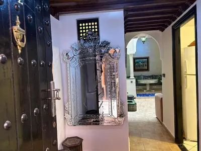 a door with a mirror on the side of a room at LOGEMENT ENTIER MARRAKECh G26 N 35 in Marrakech