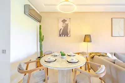 a living room with a table and a couch at Appât hôtel in Marrakech