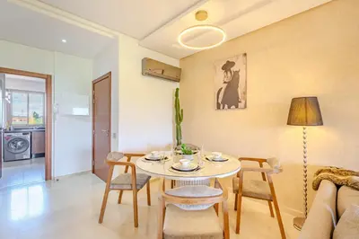 a living room with a table and chairs and a couch at Appât hôtel in Marrakech