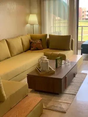 a living room with a couch and a coffee table at prestigia agate apt haut standing meublé in Marrakech
