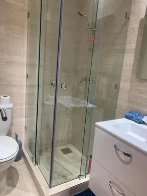 a bathroom with a shower and a toilet and a sink at prestigia agate apt haut standing meublé in Marrakech