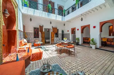 a large living room with a table and chairs at Riad Khadoj-Marrakech-Traditional in Marrakech