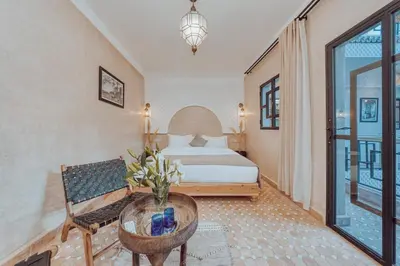 a hotel room with a bed and a table at Riad Valentine in Marrakech