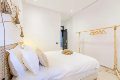 a bedroom with a white bed with white pillows at Luxe et Detente Haut standing Piscine in Marrakech