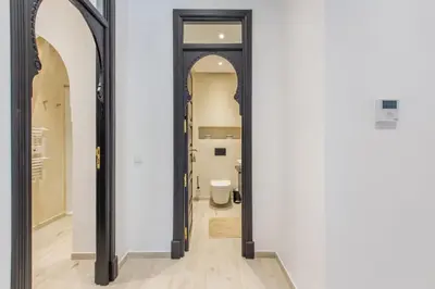 a hallway with a toilet in a room with white walls at Luxe et Detente Haut standing Piscine in Marrakech