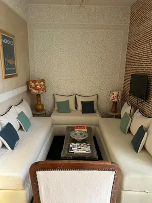 a living room with two couches and a table at Riad Dar Chalyia, private, 6 people, pool in Marrakech