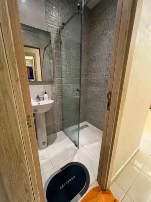a bathroom with a shower and a toilet and a sink at Family Apartment in Marrakech in Marrakech