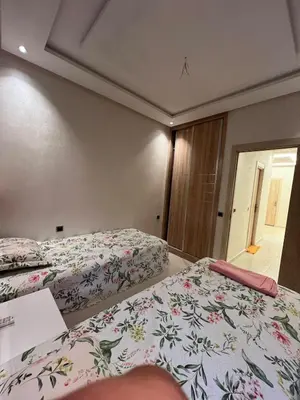 a bedroom with two beds and a window at Family Apartment in Marrakech in Marrakech