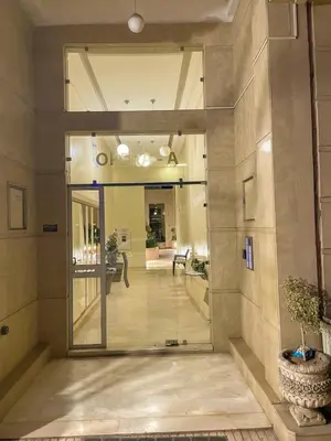 a hallway with a glass door in a building at Luxury Aprt 2 bedrooms Pool Hivernage City Centre in Marrakech