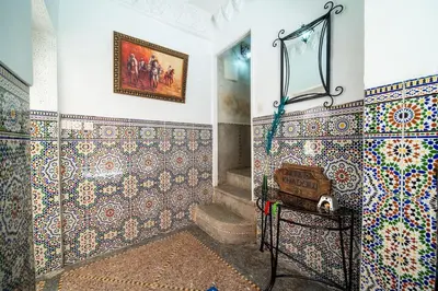a bathroom with mosaics on the walls and a mirror at Riad Khadoj-Marrakech-Traditional in Marrakech