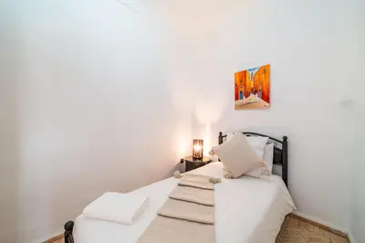 a bedroom with white walls and a bed with white sheets at Riad Khadoj-Marrakech-Traditional in Marrakech