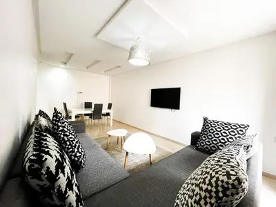 a living room with a couch and a tv at luxury Aprt2-bedrooms Pool hivernage heart of city in Marrakech