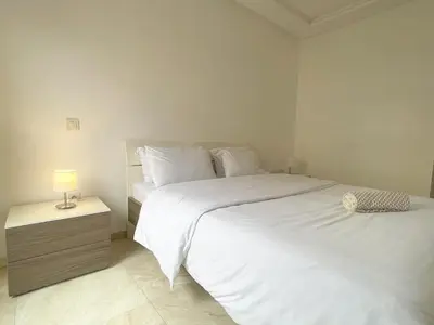 a bedroom with two beds and a lamp on a night stand at luxury Aprt2-bedrooms Pool hivernage heart of city in Marrakech