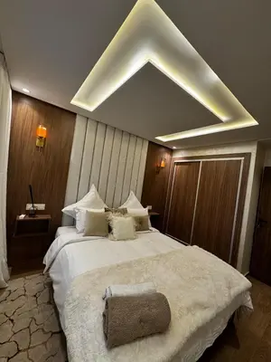 a bedroom with a large white bed with a large ceiling at Super duplex in the middle of Marrakech in Marrakech