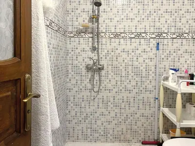 a bathroom with a shower with blue and white tiles at Maison de Vacances Idéale à 10 min de l'Aéroport in Marrakech
