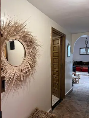 a wreath on a wall with a mirror at LOGEMENT ENTIER MARRAKECh G4 N41 in Marrakech