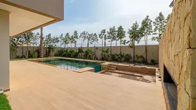 a swimming pool in the backyard of a house at Villa jardin atlas in Marrakech