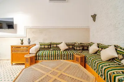 a living room with two couches and a table at Riad TESS in Marrakech