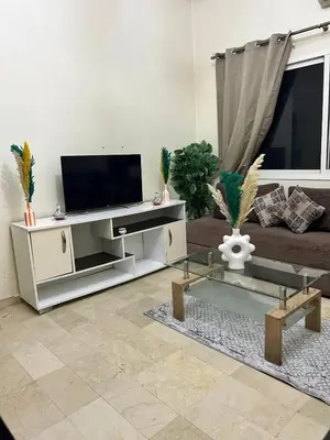 a living room with a television and a couch at Cozy Stay Close to Downtown in Marrakech