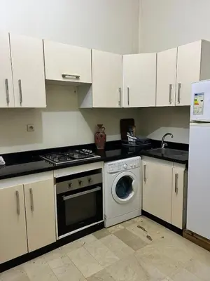 a kitchen with white cabinets and a washing machine at Cozy Stay Close to Downtown in Marrakech