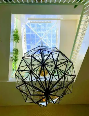 a large glass chandelier hanging from a ceiling at Riad with 3 Swimming Pools in Marrakech