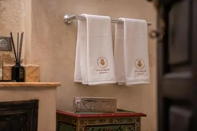 two towels hanging on a towel rack in a bathroom at Riad Al Scarabi in Marrakech