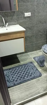 a bathroom with a sink and a toilet and a rug at Betterappart in Marrakech