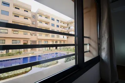 a view from a window of a building with a swimming pool at Duplex Safiya Suites and Services in Marrakech
