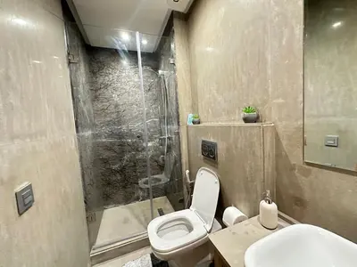 a bathroom with a shower and a toilet and a sink at NEW LUXURY APARTMENT - HEART Of MARRAKECH in Marrakech
