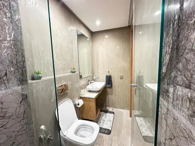 a bathroom with a toilet and a sink and a shower at NEW LUXURY APARTMENT - HEART Of MARRAKECH in Marrakech