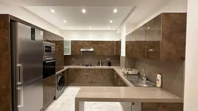a kitchen with a sink and a refrigerator at NEW LUXURY APARTMENT - HEART Of MARRAKECH in Marrakech