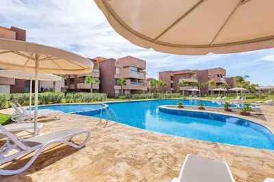 an image of a swimming pool with chairs and an umbrella at Breathtaking views of golf in Marrakech