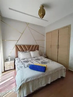 a bedroom with a bed with a blue pillow on it at Marrakech Luxury ATLAS in Marrakech