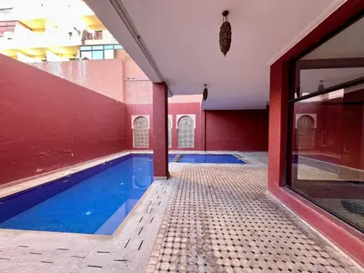 a swimming pool in the middle of a building at Appartement idyllique au centre ville in Marrakech