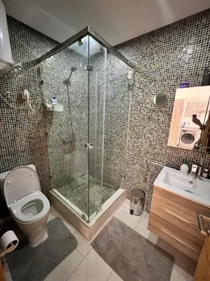 a bathroom with a shower and a toilet and a sink at Hoteghani in Marrakech