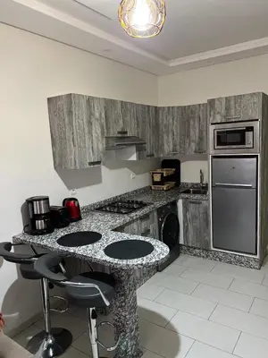 a kitchen with a granite counter top with a stove top oven at Hoteghani in Marrakech