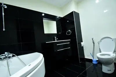 a black bathroom with a white tub and a toilet at holiday villa in marrakech in Marrakech