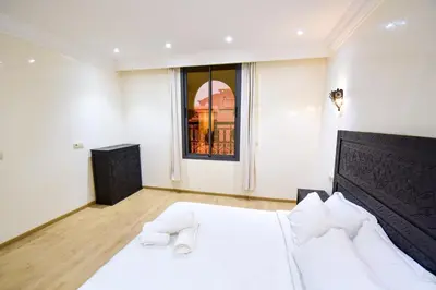 a bedroom with a large white bed with white pillows at holiday villa in marrakech in Marrakech