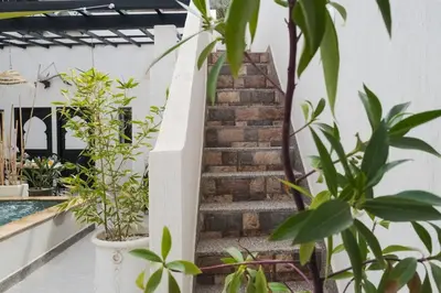 a staircase leading up to a house with plants at Elegant Marrakech Villa with Optional Heated Pool for Ultimate Relaxation in Touggana