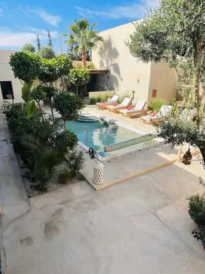 a swimming pool with lounge chairs in a backyard at Run Villa Marine, Elegant Private Villa in Marrakech with Heated Pool Option in Marrakech