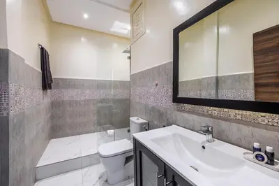a bathroom with a sink and a toilet and a mirror at Cocon Chaleureux au Cœur de la Ville in Marrakech