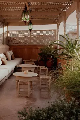 a living room with a couch and tables and a patio at Riad Berbère Marrakech in Marrakech