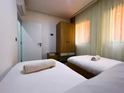 a room with two beds with towels on them at Hivernage appartement premium in Marrakech