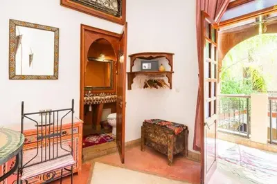 a room with a bedroom with a mirror and a window at superbe riad en exclusivité B&B in Marrakech