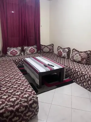 a living room with a couch with a table at Yassmirouaq in Marrakech