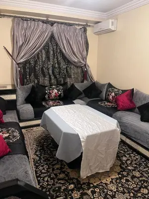 a living room with a couch and a table at Yassmirouaq in Marrakech