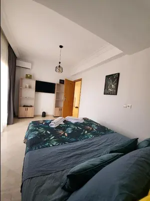 a bedroom with a large bed in a room at Wonderful apartment pool residence Babylon 2- chambre in Marrakech