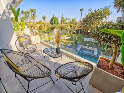 a patio with chairs and a swimming pool at Villa Beverly hills-luxury home in Marrakech